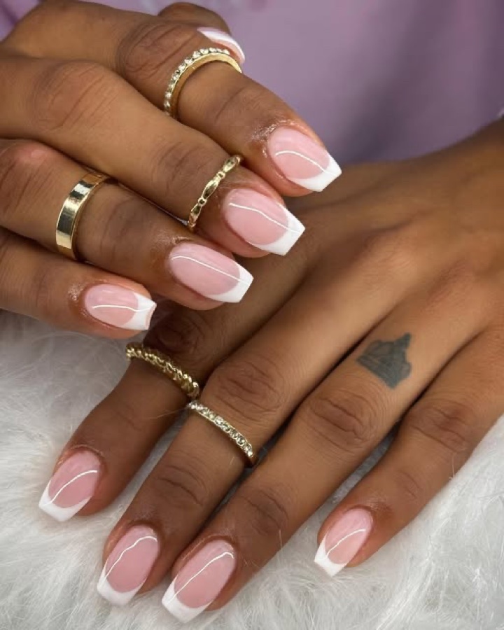 French tip gel manicure with gold rings