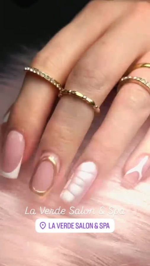 Short natural nails with a white French line and gold rings